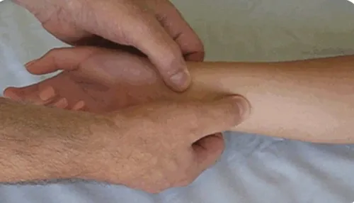 therapist performs myofascial release on a patient's wrist