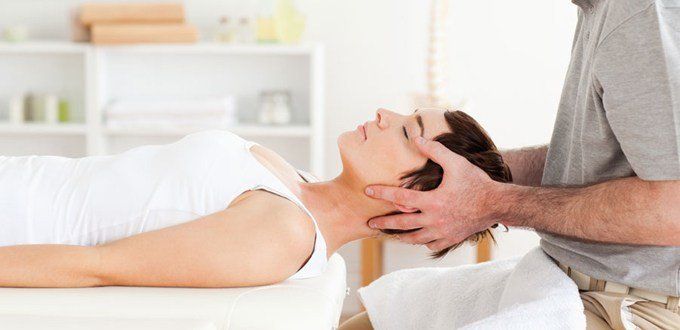 Doctor stretches a patient's neck to treat cervical radiculopathy.