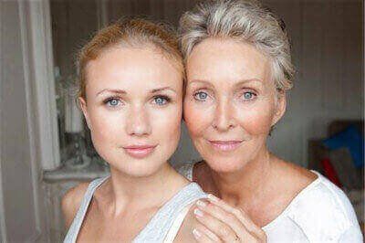 Attractive and fair-skinned mother and daughter pose cheek-to-cheek for a happy picture.
