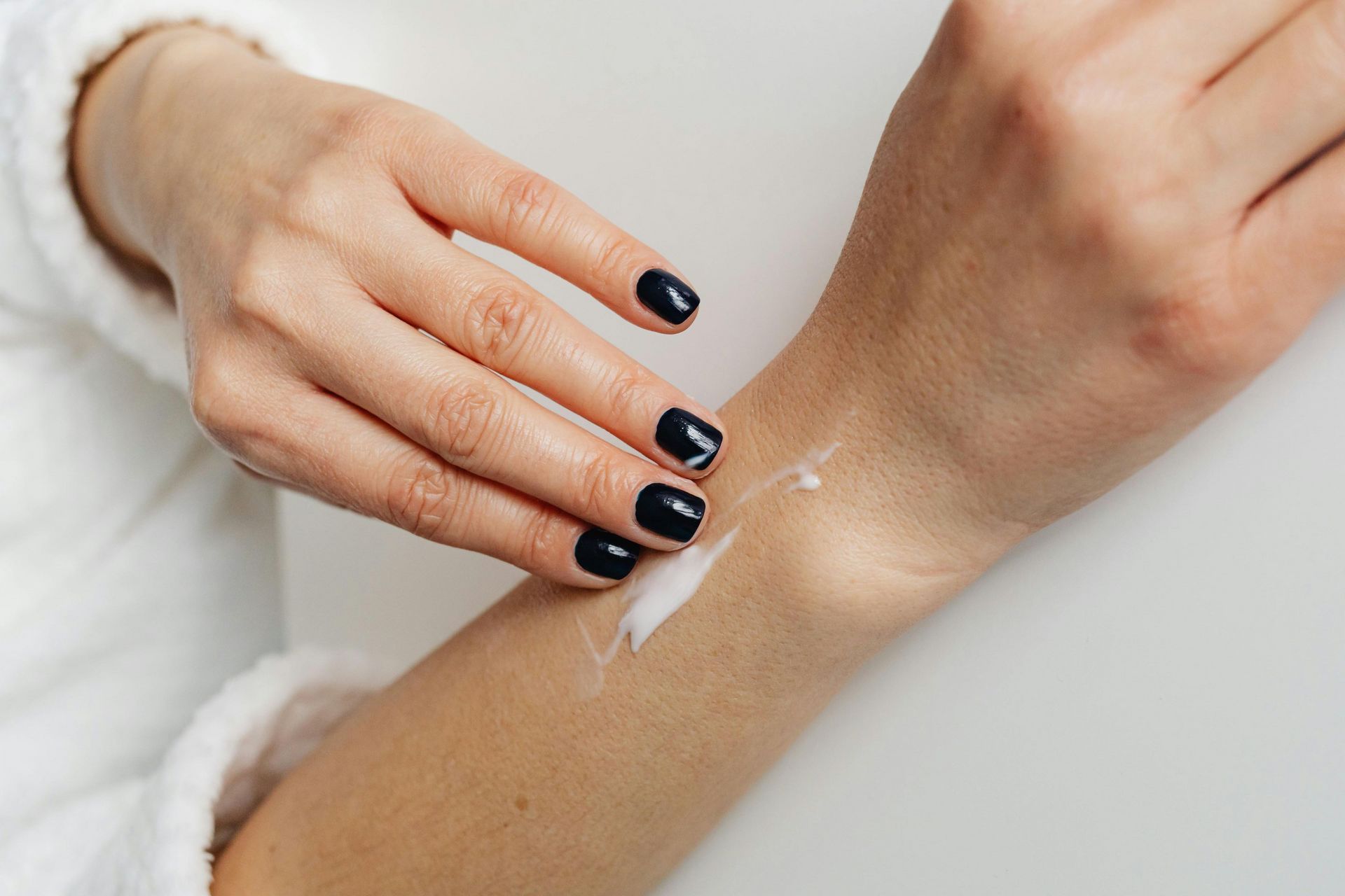 woman applying ointment to her wrist