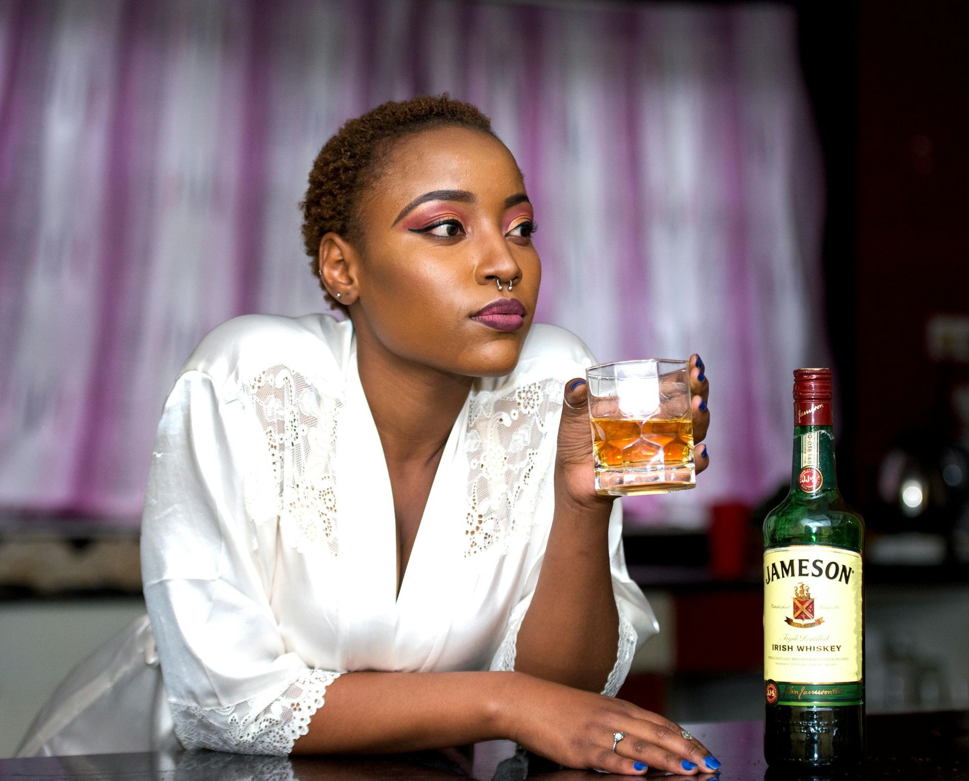 young black woman drinking whiskey