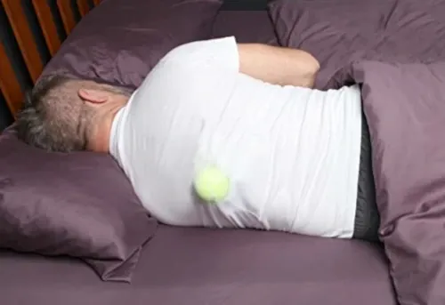 tennis ball in a T-shirt to avoid sleeping on your back