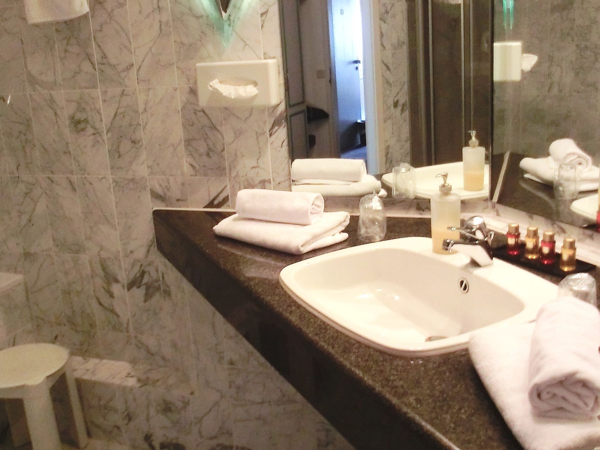 Ein Badezimmer mit Waschbecken und Handtüchern auf der Ablage