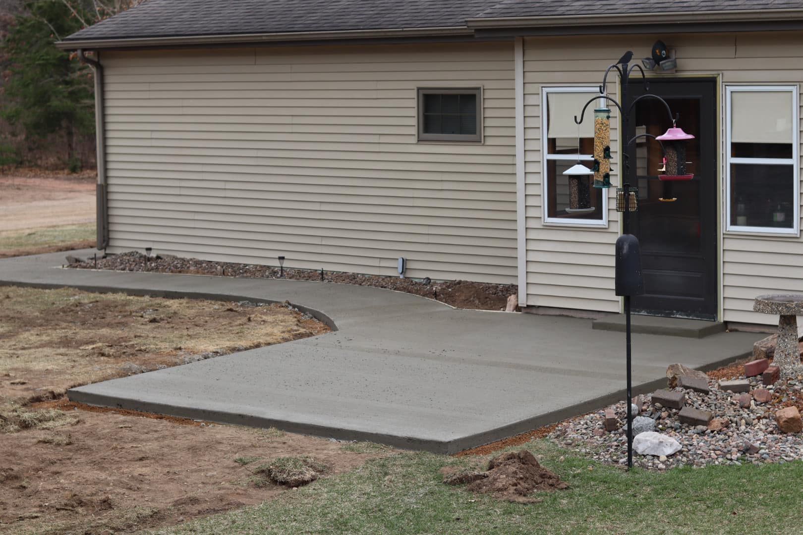 A truck is parked in a driveway in front of a house.