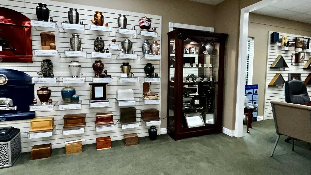 A showroom displaying various cremation urns of different sizes, shapes, and materials.