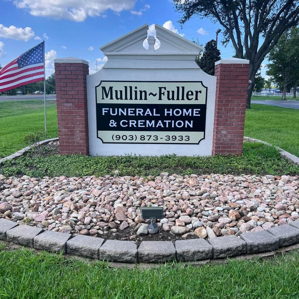 Sign for Mullin~Fuller Funeral Home with the American flag in front.
