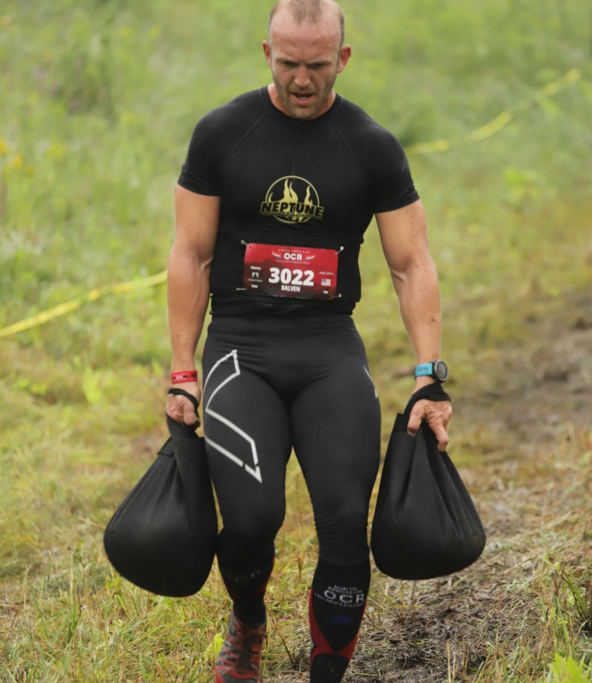 A man wearing a black shirt with the number 3022 on it