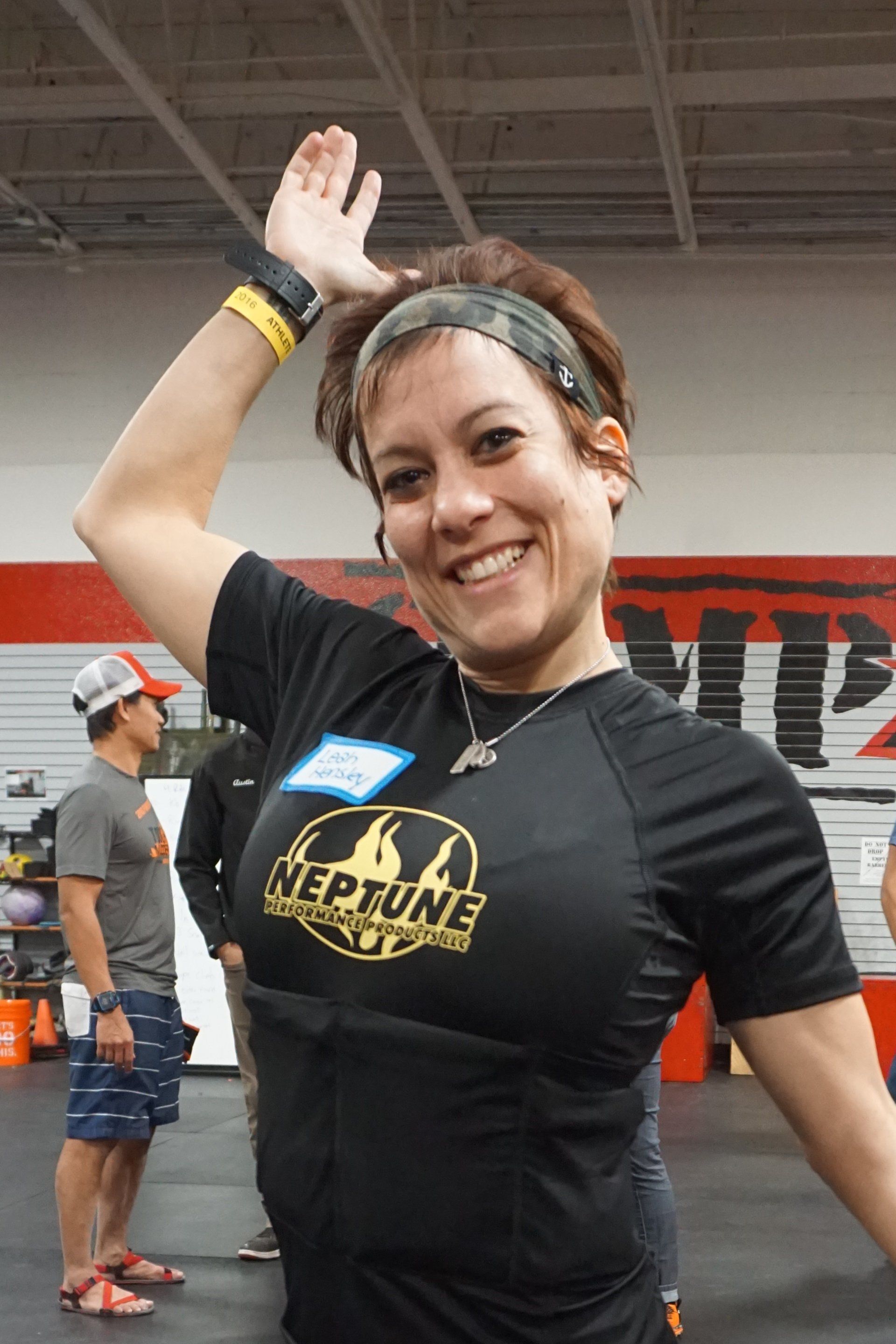 A woman wearing a black shirt with the word neptune on it