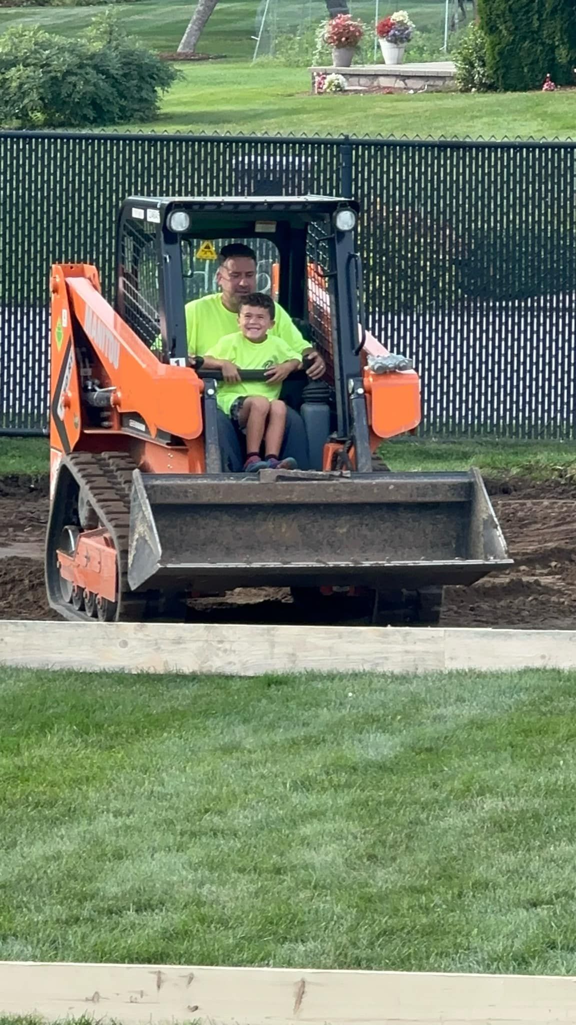 A man is standing next to a dumpster filled with trash.