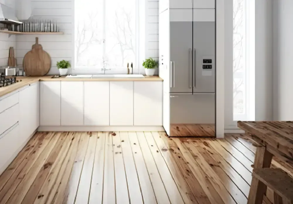 Bright modern kitchen with white cabinets, stainless fridge, wood countertops, and wide plank floor