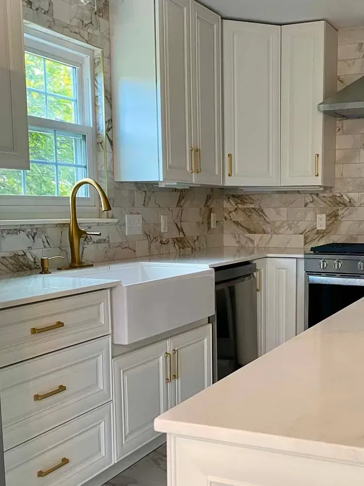 Luxury bathroom with granite vanity, large mirror, and a white soaking tub by a window.