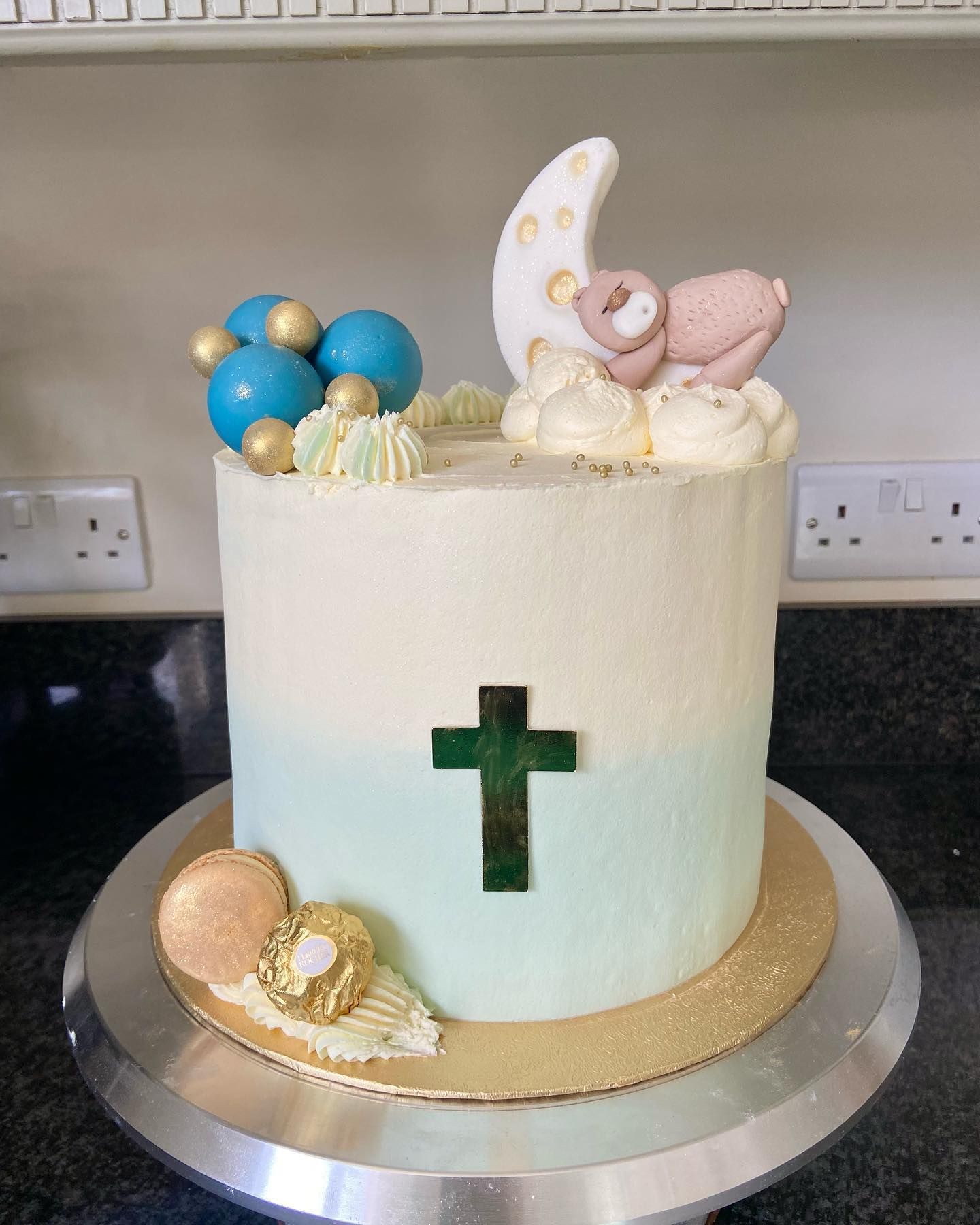 A cake with a cross and a baby on it