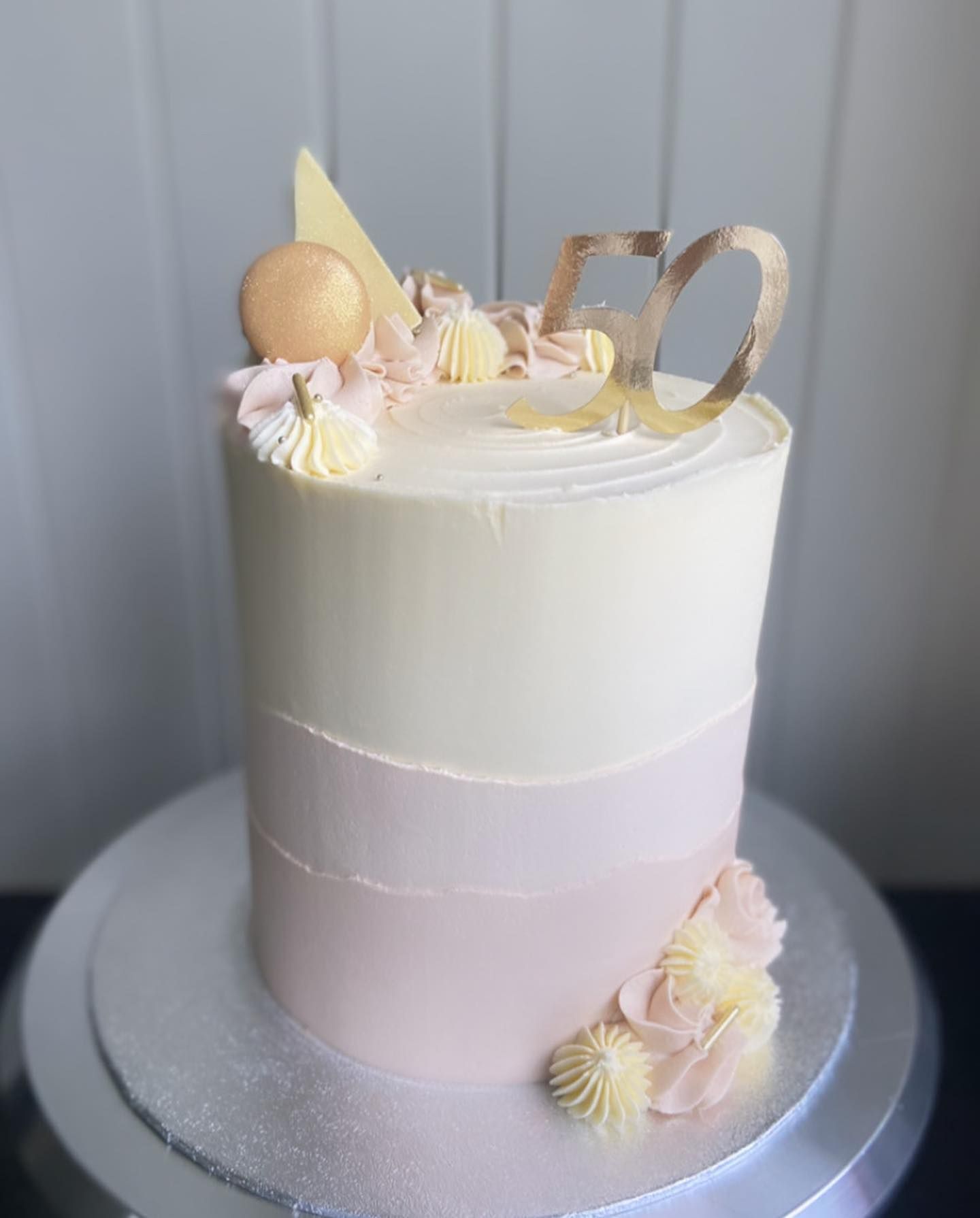 A cake is sitting on top of a silver plate on a table.