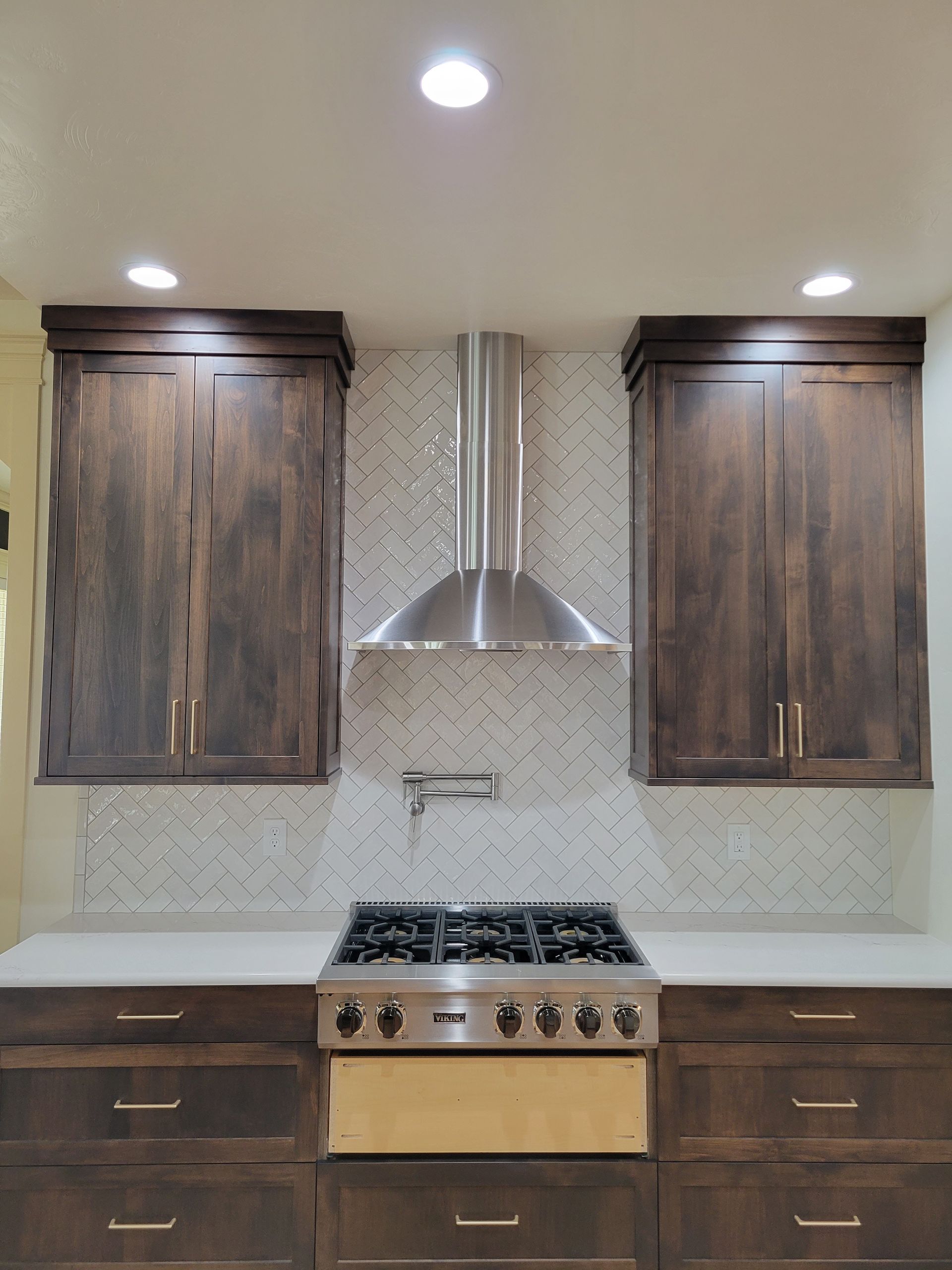 A kitchen with wooden cabinets and a stove top oven