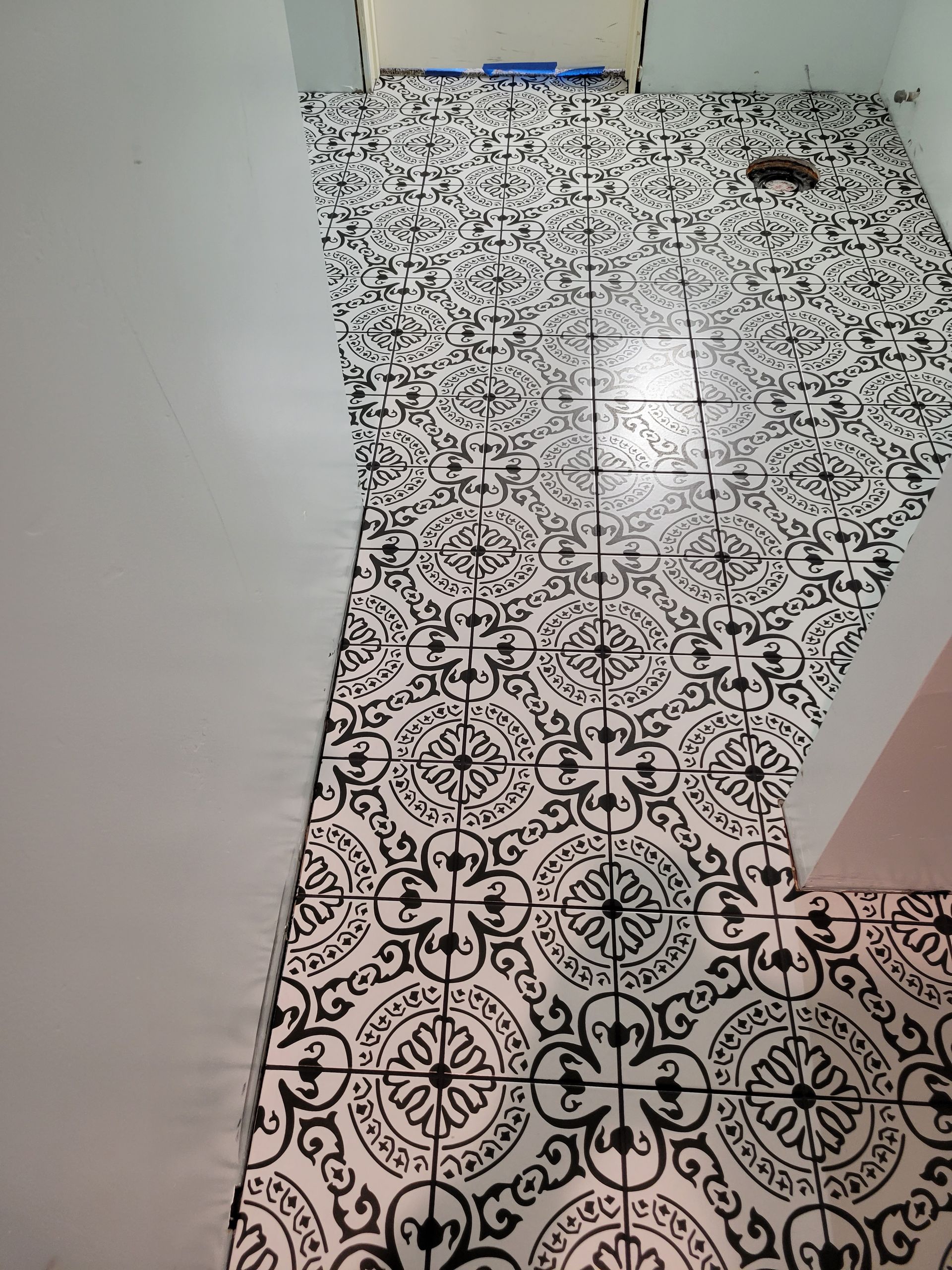 A black and white tile floor in a bathroom.