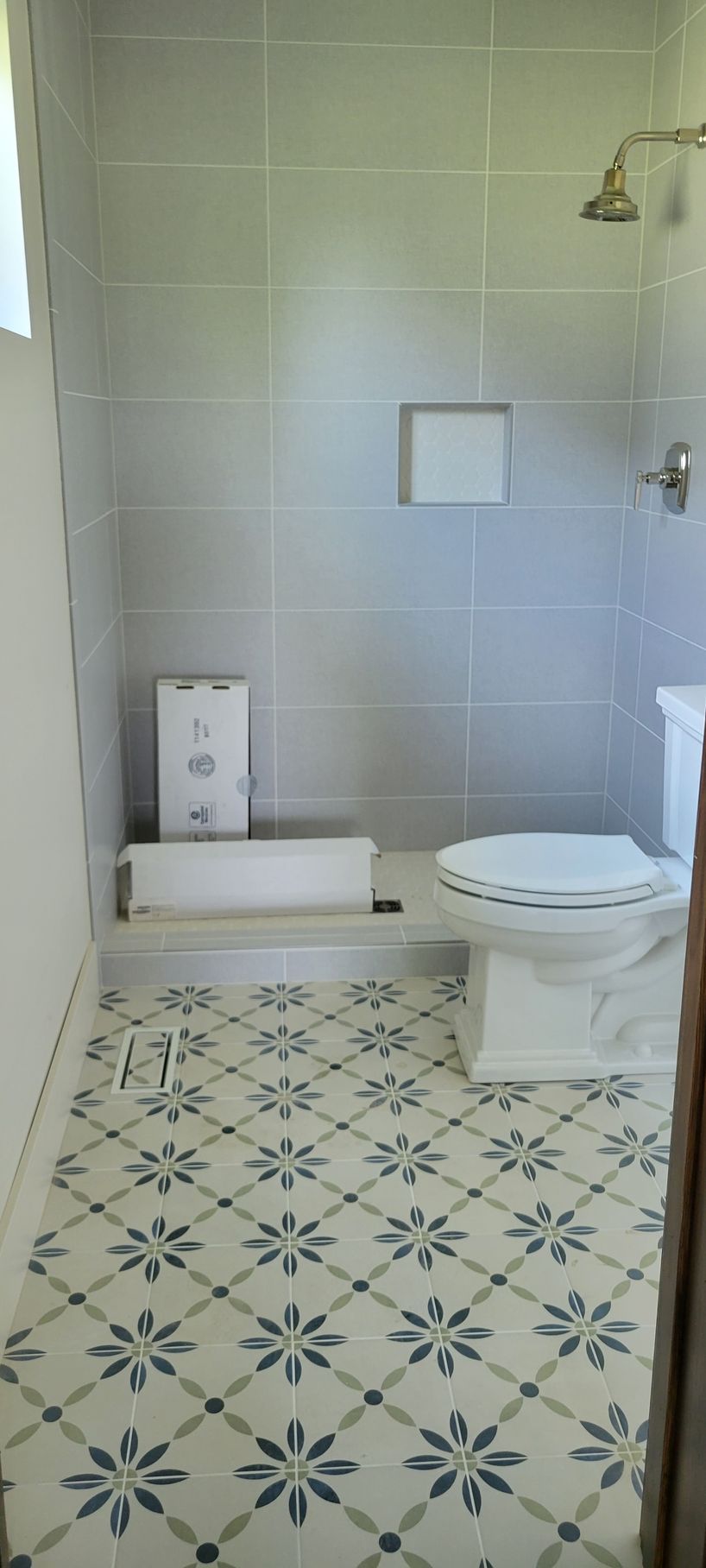 A bathroom with a toilet , tub and shower.