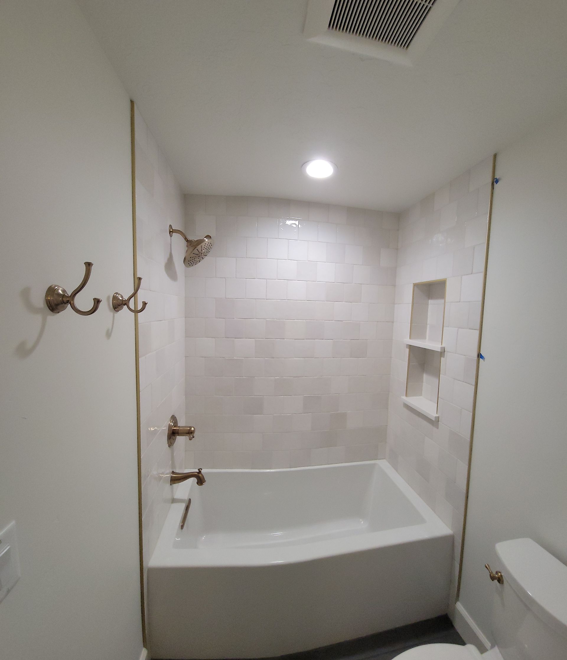A bathroom with a bathtub and a toilet