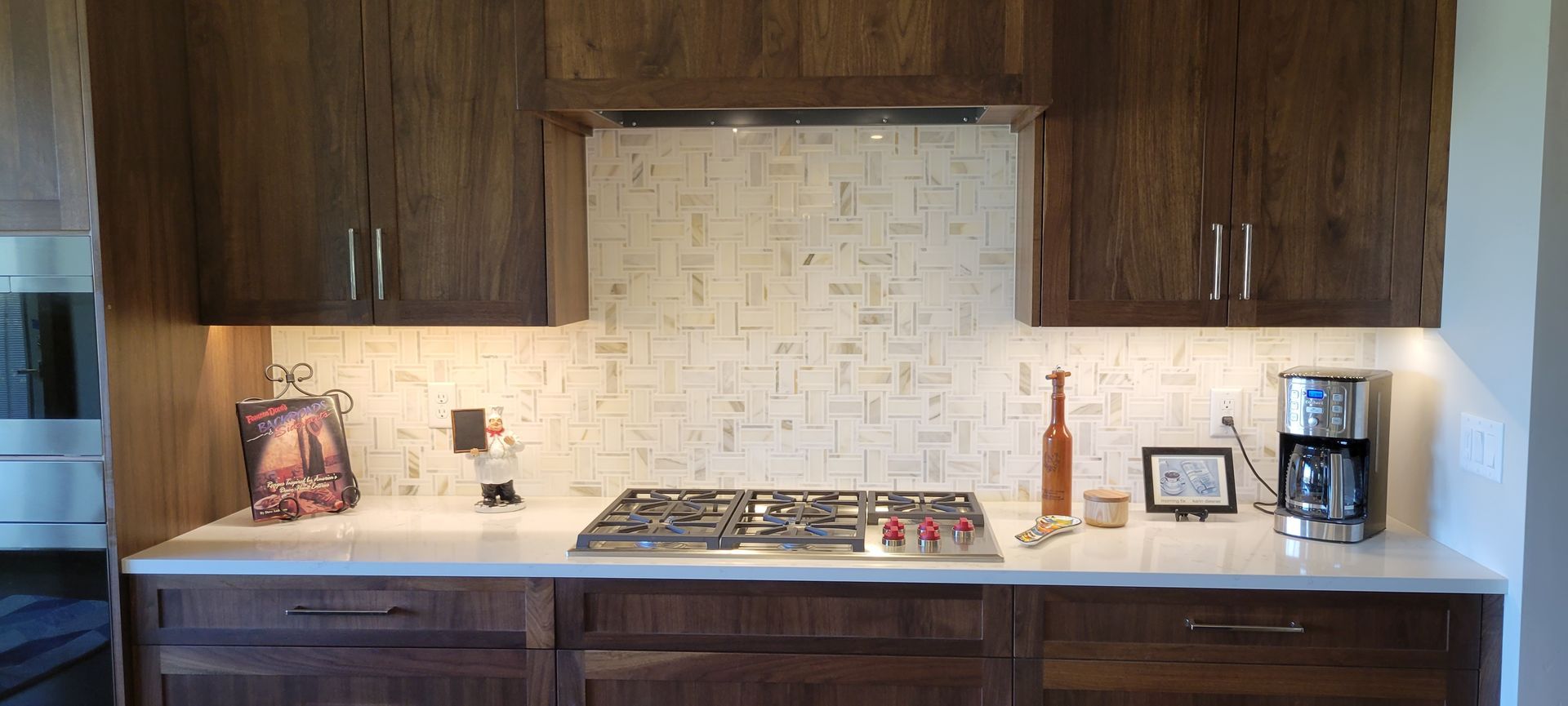 A kitchen with wooden cabinets and a stove top oven.