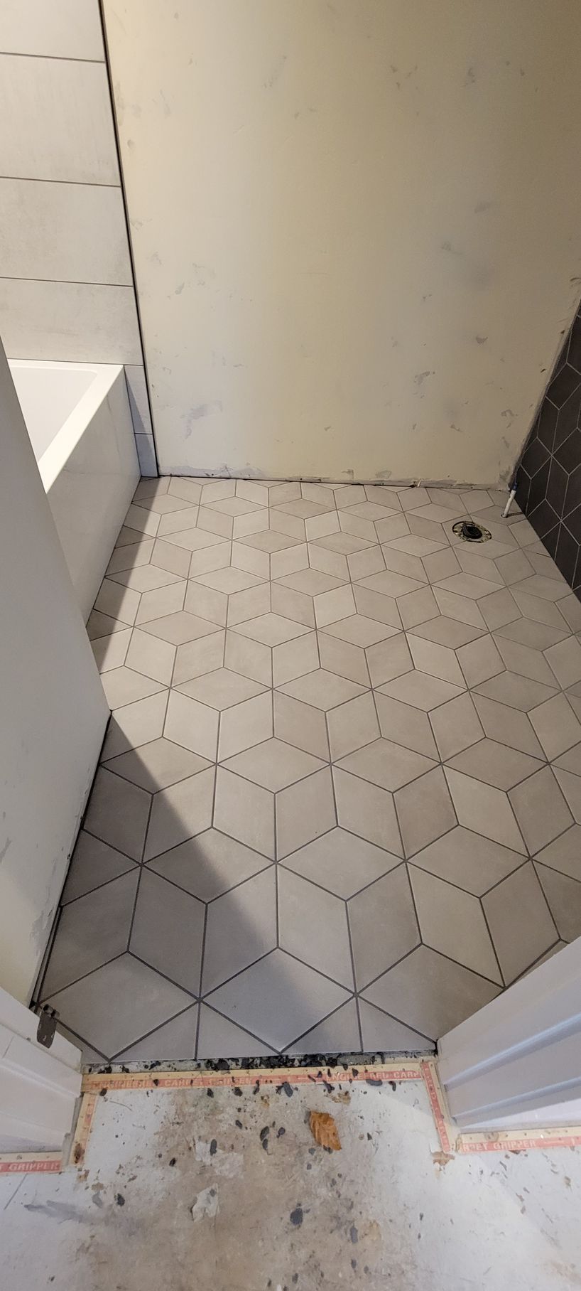 A bathroom with a tiled floor and a door.