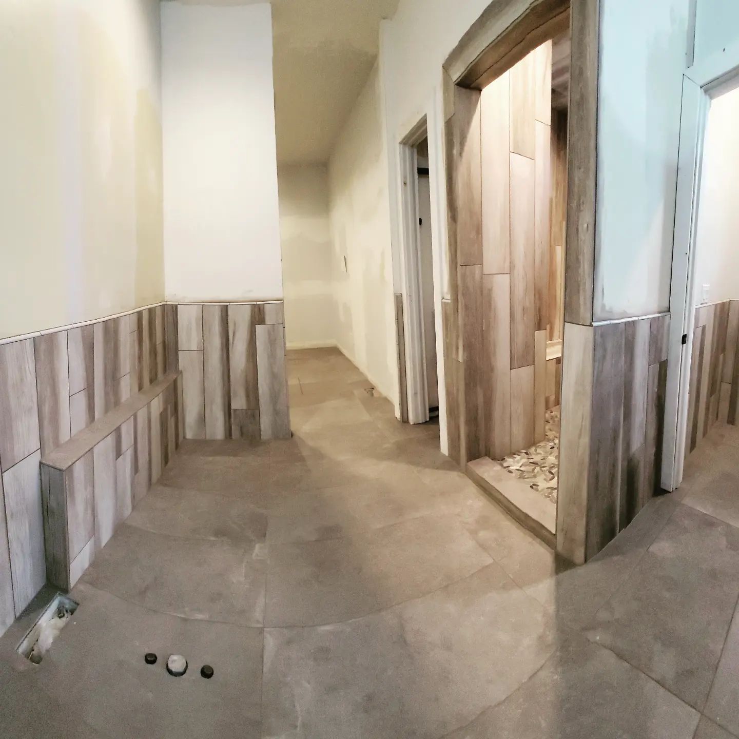 A hallway with a few doors and a few stones on the floor