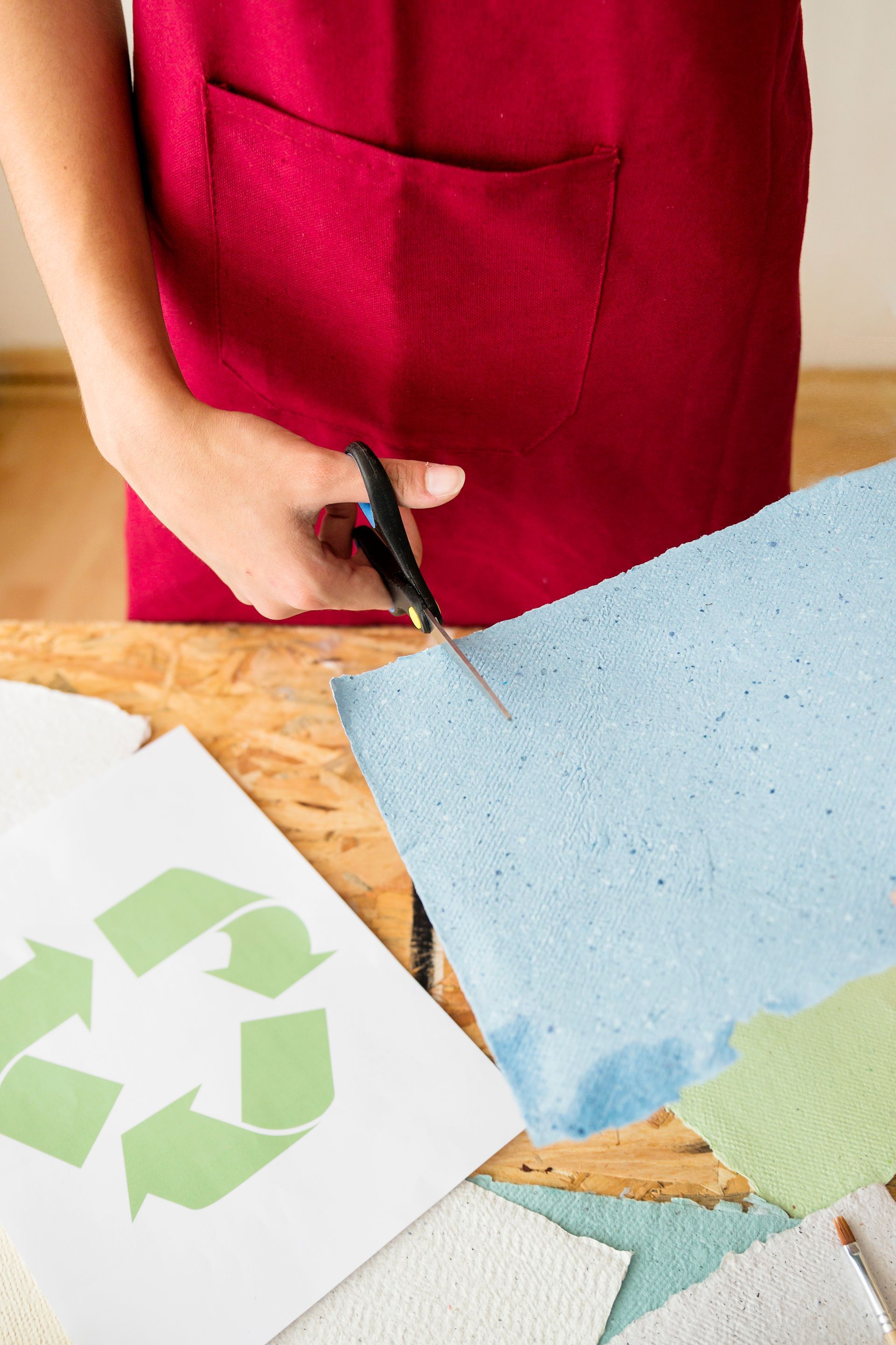 A person is cutting a piece of paper with scissors.