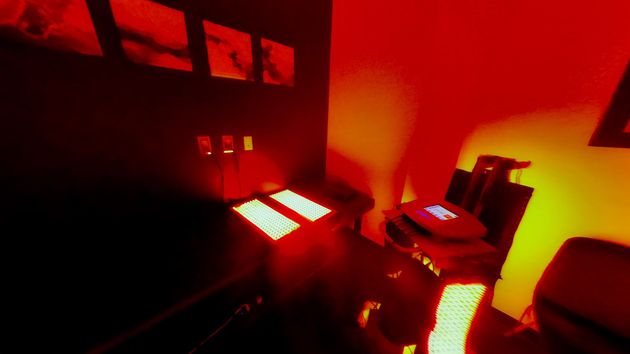 A dark room with red lights on the walls