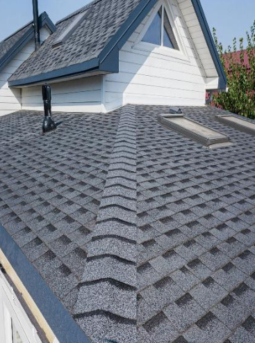 Woman in straw hat smiles, holding wine glass near a lake.