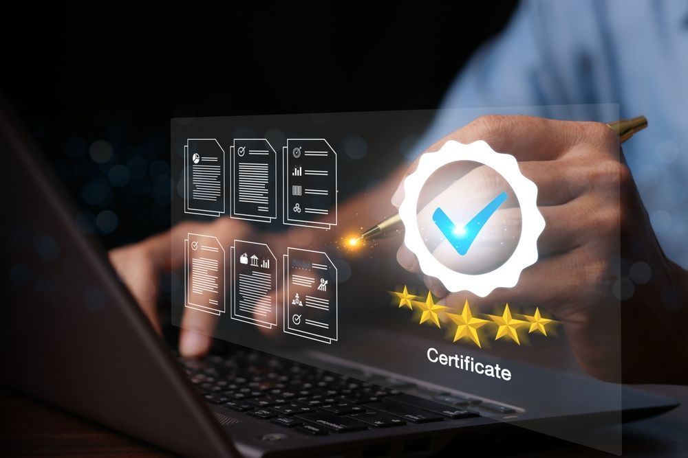 Person on laptop with hovering screen showing a check mark and stars for certification