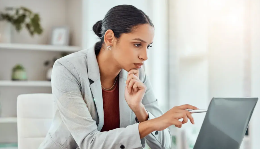Woman using pen to interact with tablet while working