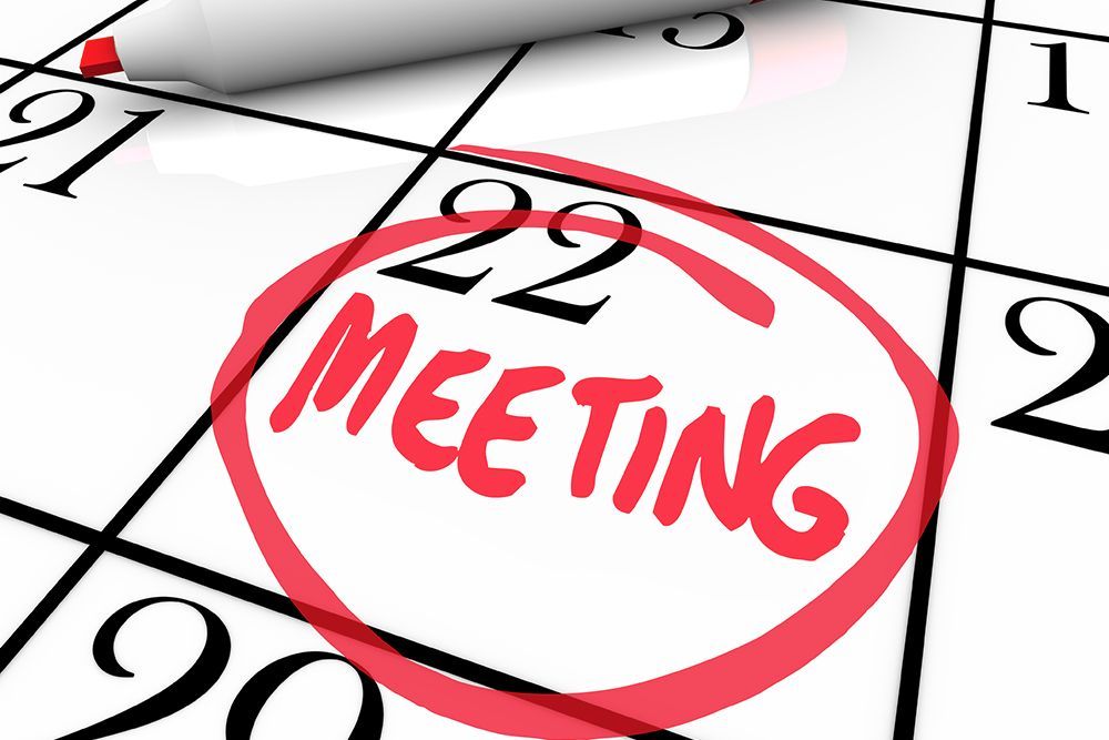 Calendar page with red circled “MEETING” written on it