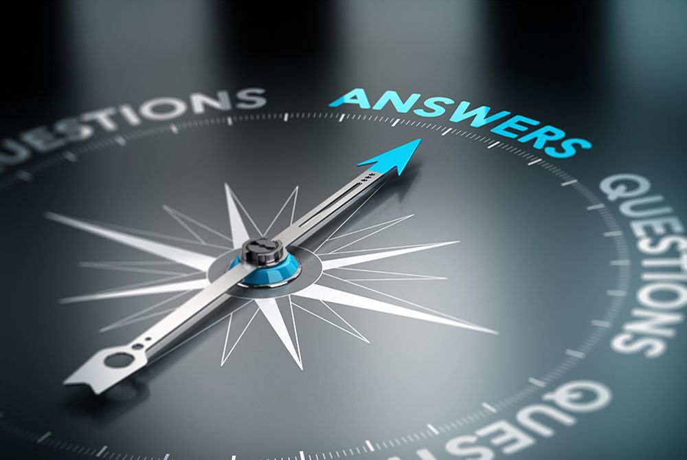 Compass needle pointing to “ANSWERS” amid surrounding “QUESTIONS” text on a dark background