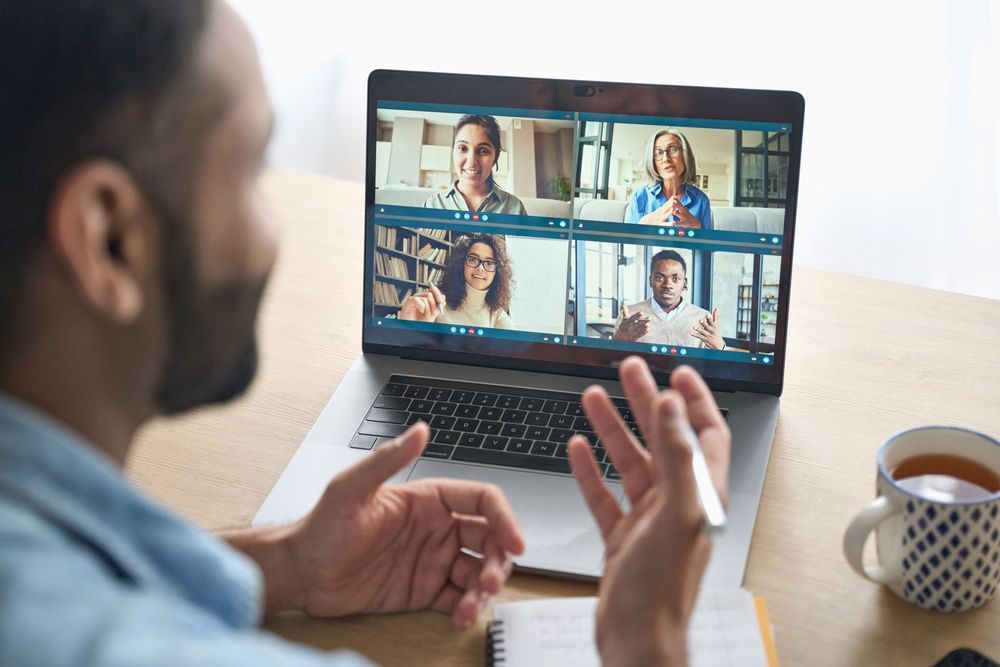 Man holding online discussion with four other individuals