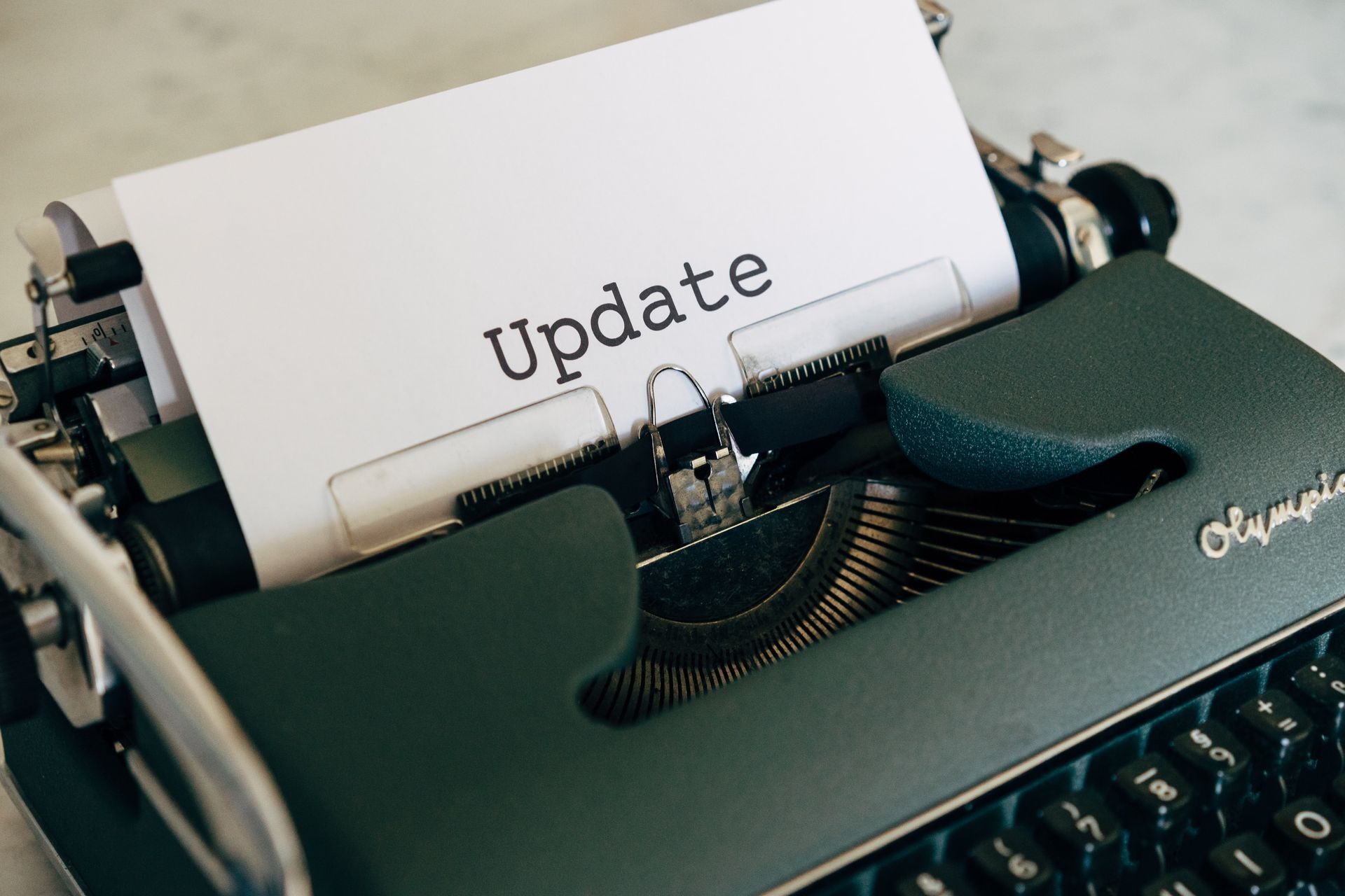 Close-up of a vintage typewriter with a page reading “Update” inserted