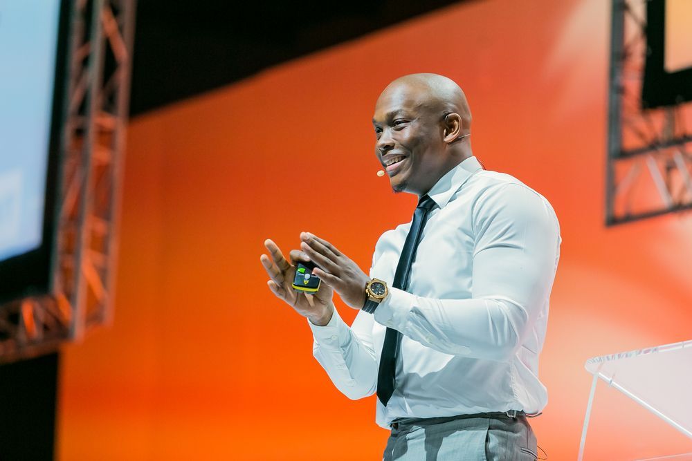 Man speaking on stage at conference