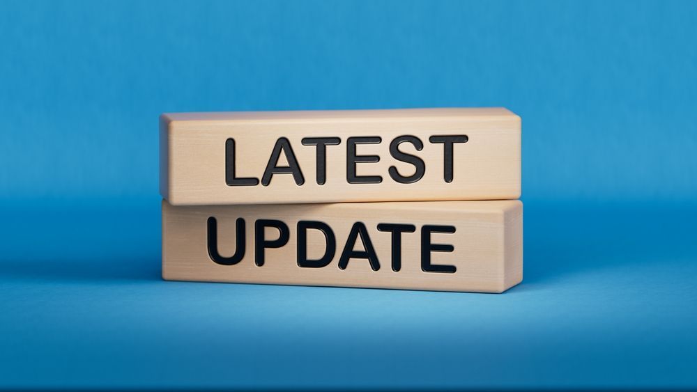 Wooden blocks reading “LATEST UPDATE” on a blue background
