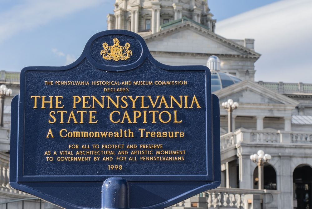 A blue Pennsylvania Historical and Museum Commission marker for the Pennsylvania State Capitol, with the building behind.