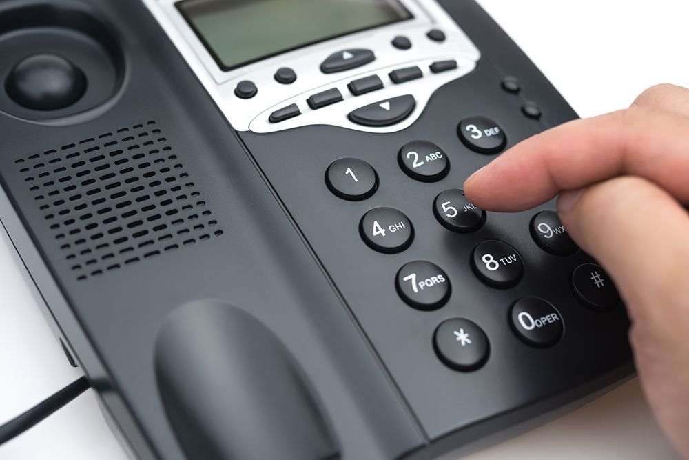 Person pushing buttons on a phone to join call