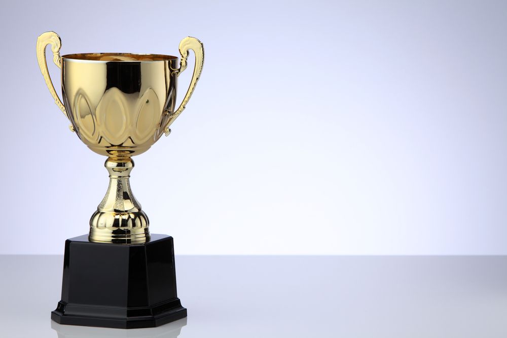 Brass trophy on white table