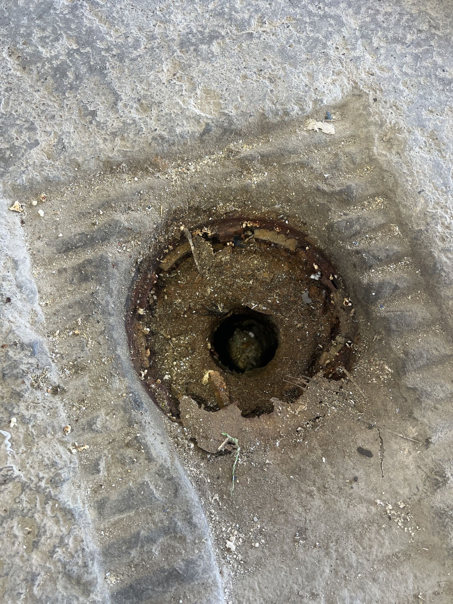 A close up of a hole in the ground with water coming out of it.