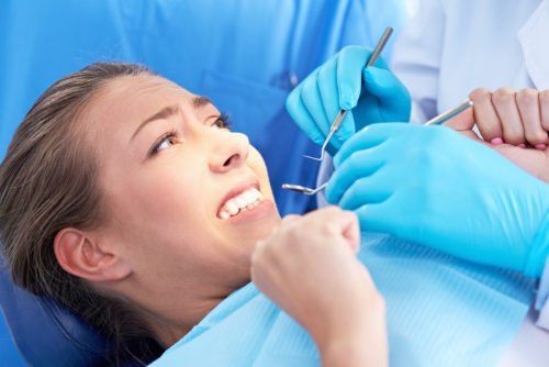 anxious woman at the dentist, overcoming dental anxiety blog
