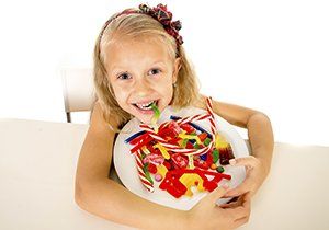 kid with candy on plate, sweet and tooth decay blog