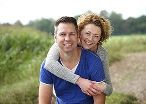 middle age couple smiling and hugging - what is gingivitis blog