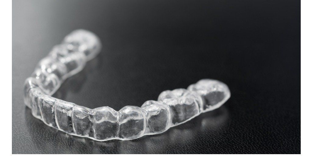 clear-dental-retainer-on-black-surface