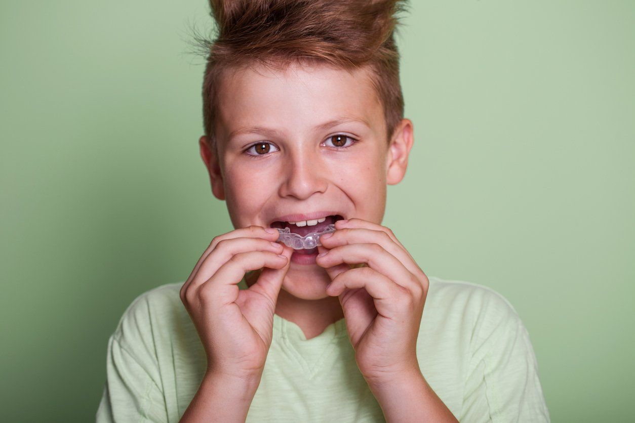 boy putting in mouth guard