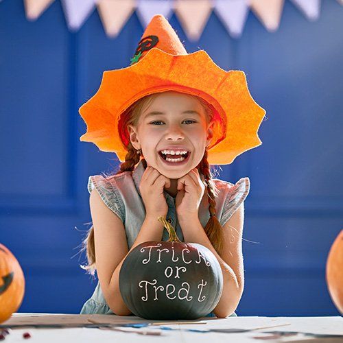 cheerful kid wearing a witch custom