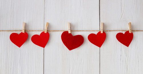 red paper cut heart shaped hanging on string by clip, 