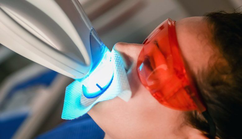 patient at the dentist, home v. professional teeth whitening blog