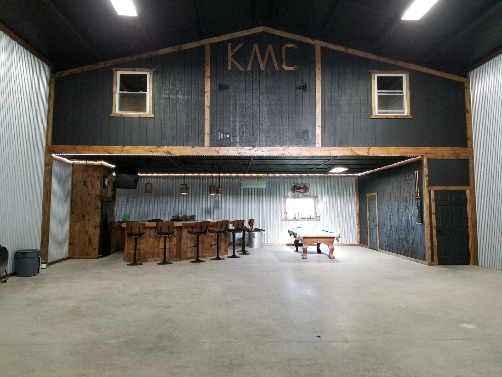 Inside a barndominium built by Klassen's Metal Construction with a bar and a pool table