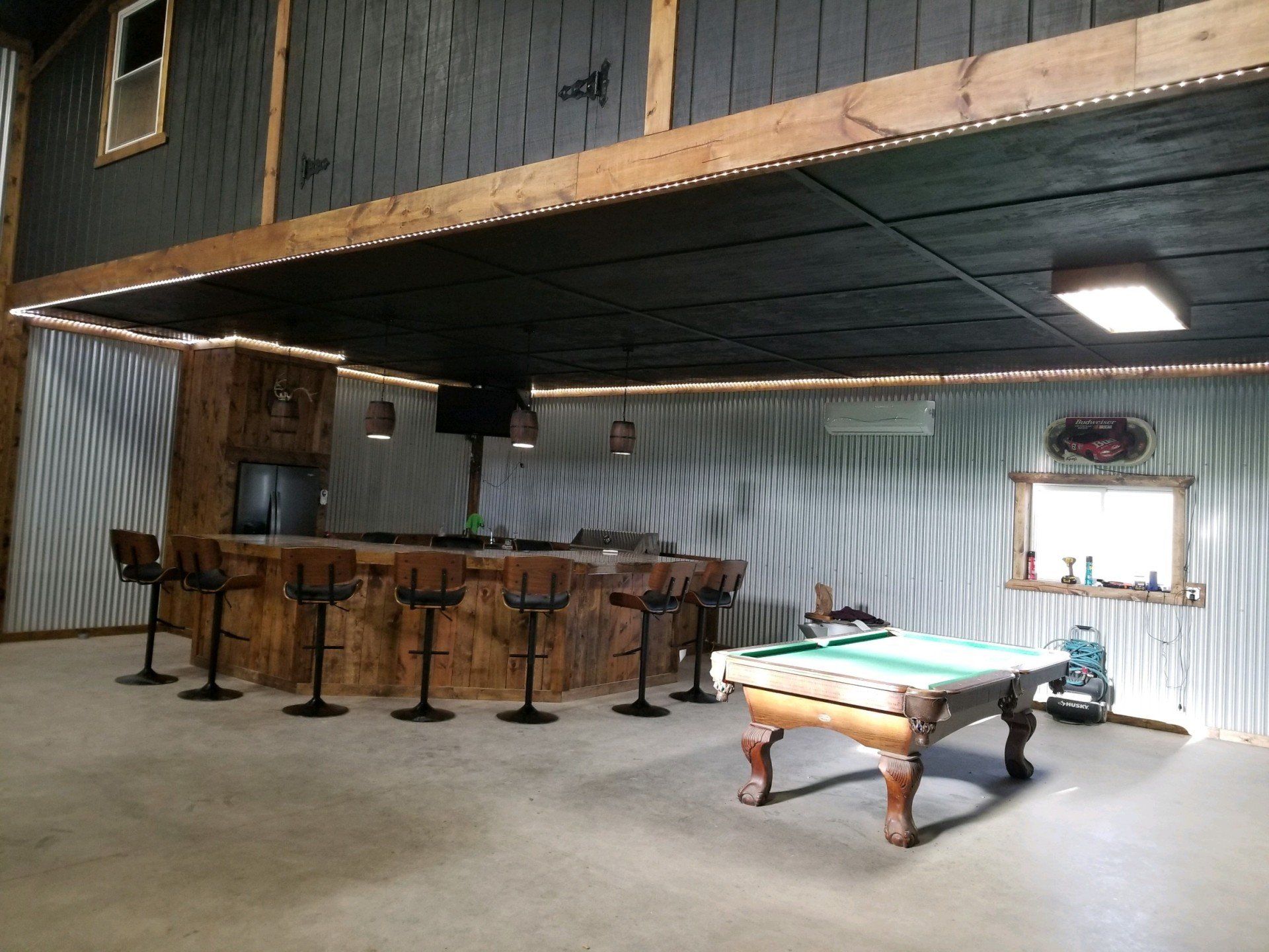 Inside a barndominium with a bar and a pool table created by the contractors at Klassen's Metal Construction