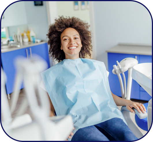 Happy patient sitting in dentist chair